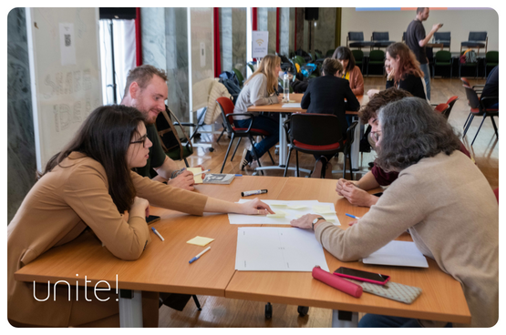 picture of a team working in a table during the IDEM bootcamp