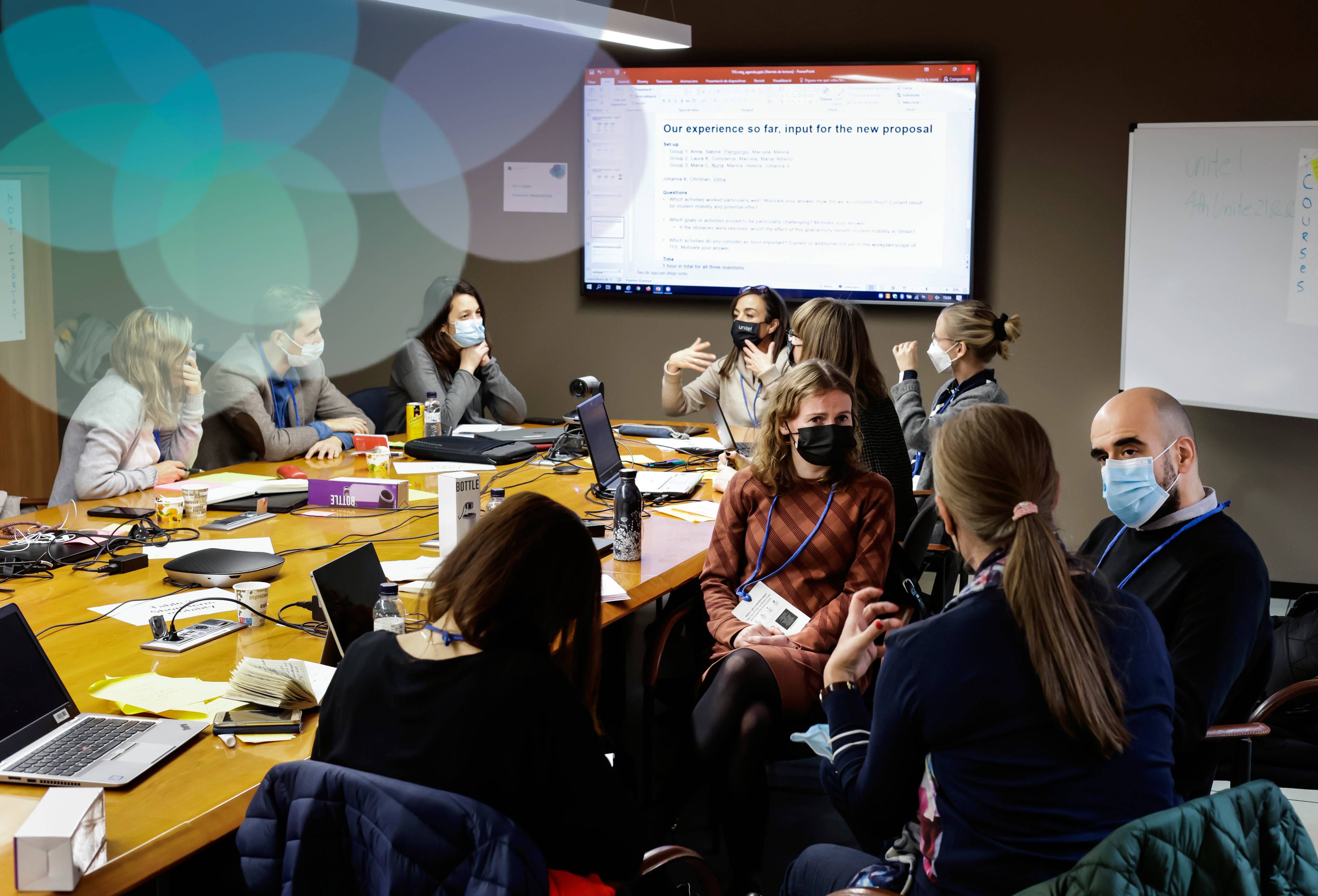 A photograph of various members of the Unite! community during a meeting.