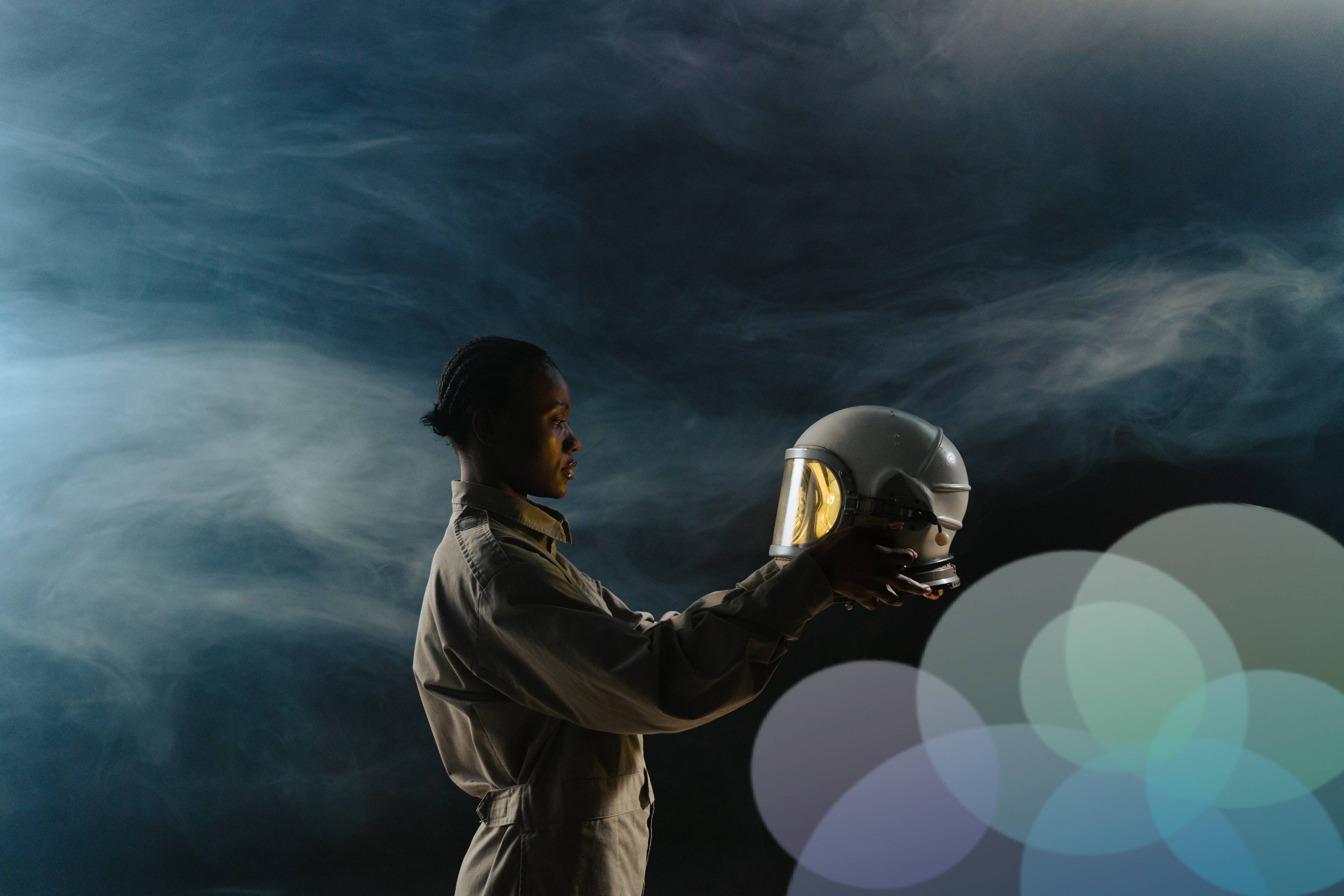 See larger image Image of an astronaut holding her helmet