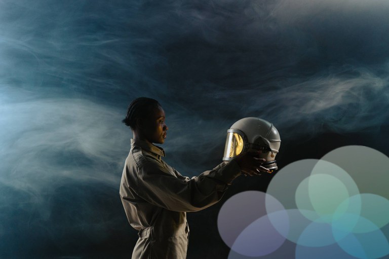Image of an astronaut holding her helmet