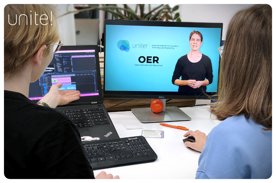See larger image Image of two students looking at a screen that says OER courses