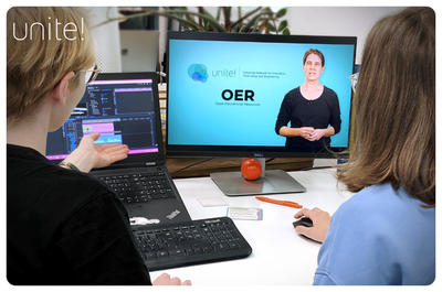 Image of two students looking at a screen that says OER courses