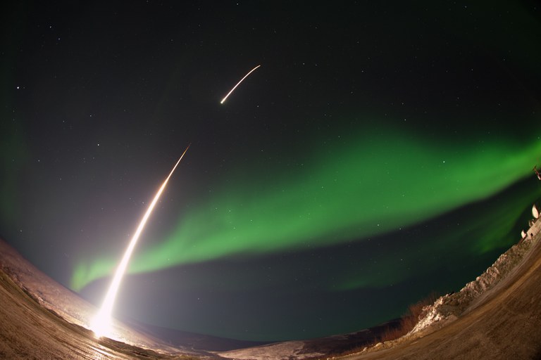 An image of a NASA-funded sounding rocket launches into an aurora over Venetie, Alaska.