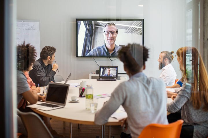 An online meeting with people interacting.