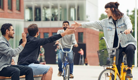 See larger image Three students interacting within a university environment