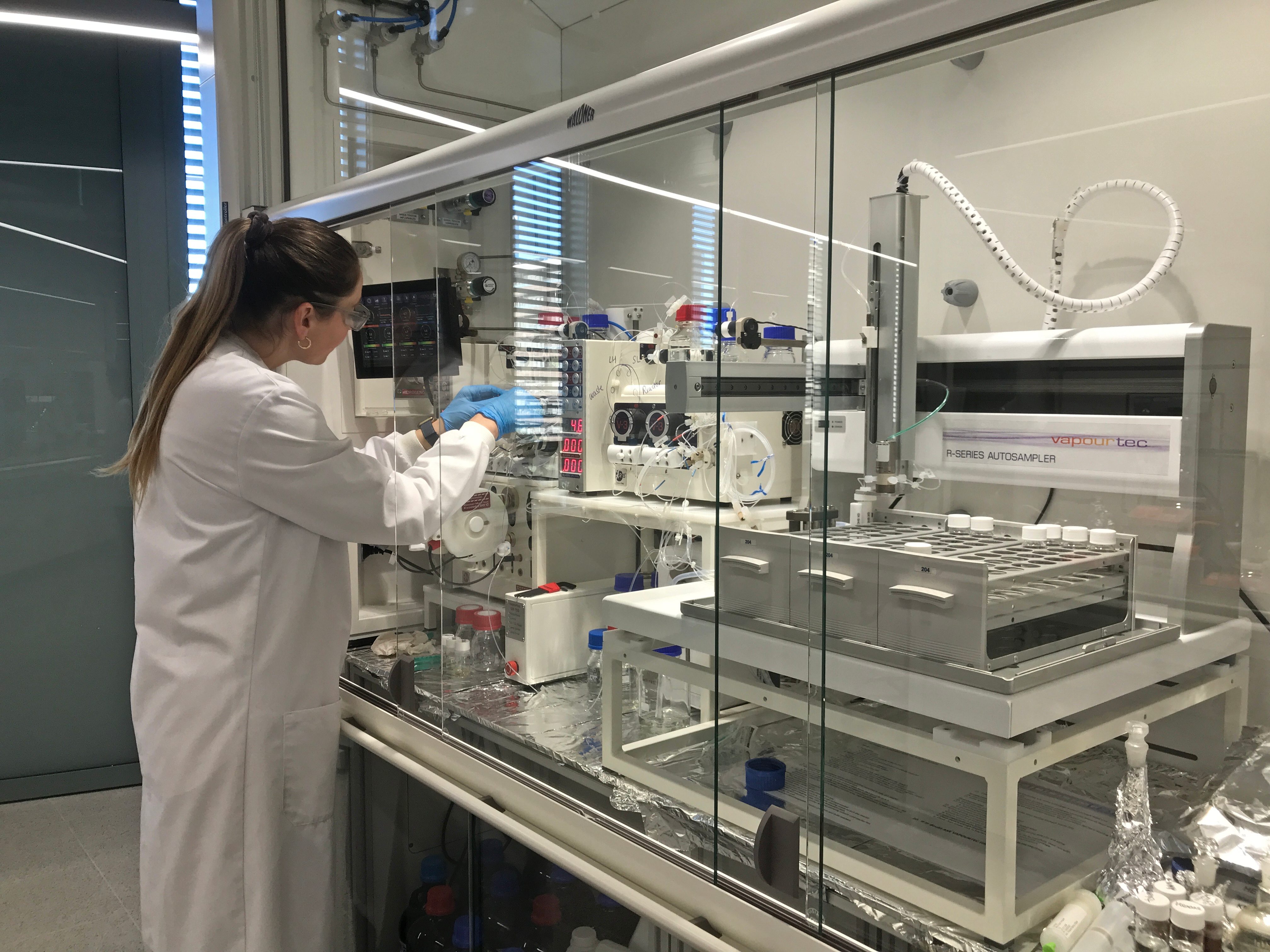 Student using a lab equipment during a research equipment