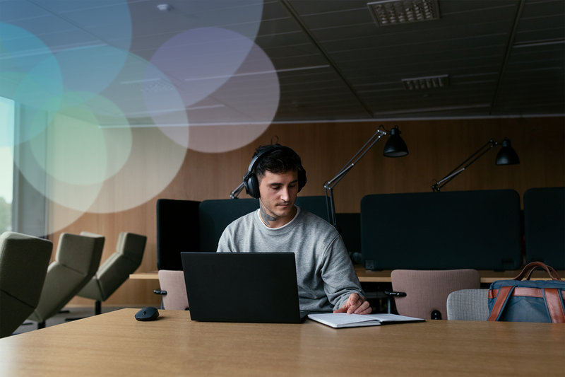 A student looking at a laptop.